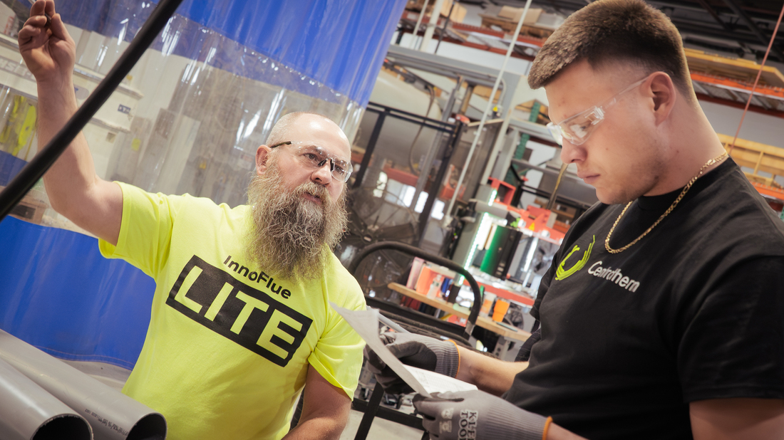 two men speaking within the production floor