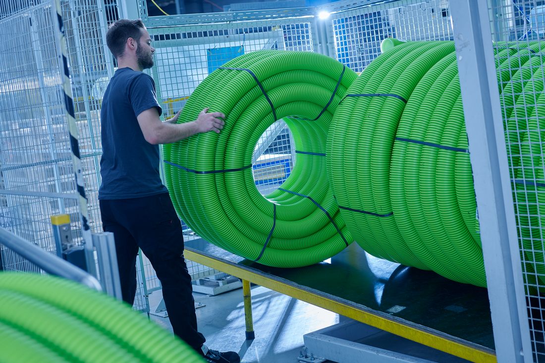 man holding green pipes