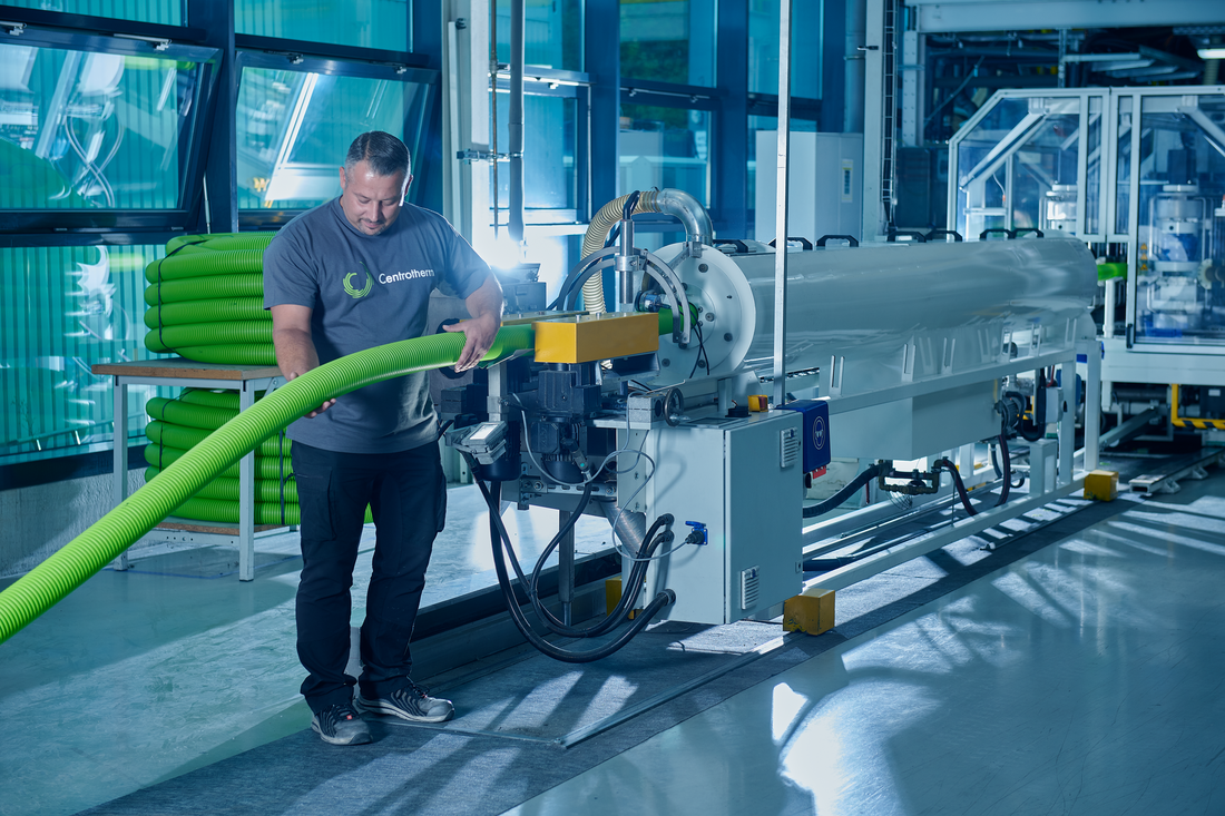 Centrotherm worker operating a machine that produces Air Excellent inside a factory.